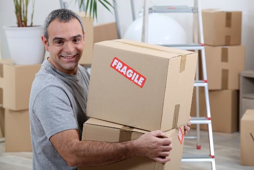 Professional movers loading household items for a South London move