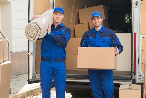 Local removal van outside a modern apartment building