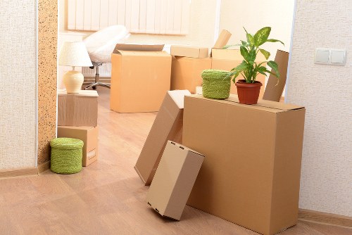 Movers handling office furniture in a busy South London area